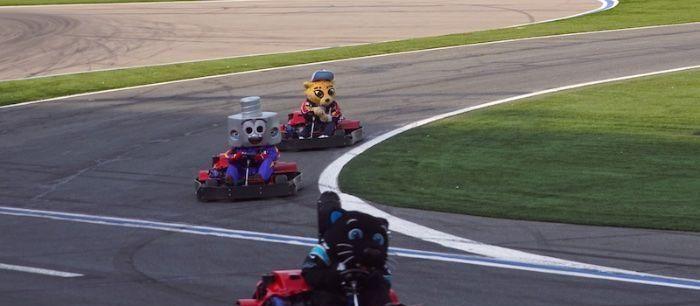 Carolina Panthers mascot Sir Purr leads Charlotte Motor Speedway's Lug Nut and the NASCAR Hall of Fame's Champ the Cheetah during Cook Out Summer Shootout action on Monday night at Charlotte Motor Speedway.