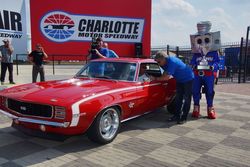 Mount Holly, North Carolina's Dan Herzberg chats with NASCAR on FOX personality Mike Joy after Herzberg's 1969 Chevrolet Camaro won Best of Show honors in Sunday's Fall AutoFair at Charlotte Motor Speedway