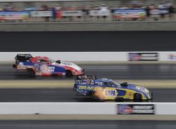Ron Capps leads Robert Hight across the line during Sunday's Funny Car eliminations in the NHRA Four-Wide Nationals at zMAX Dragway
