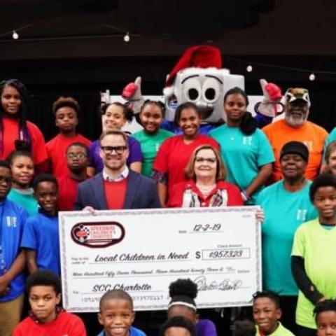 Speedway Children’s Charities Vice Chairman and Charlotte Chapter President Marcus Smith (center left) and Charlotte Chapter Director Lisa Starnes join children from area non-profits who were granted nearly $1 million during a special ceremony on Monday.