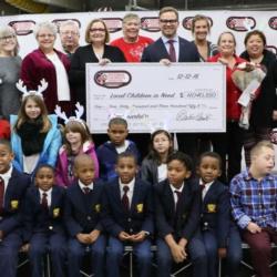 Speedway Children’s Charities Vice Chairman and Charlotte Chapter President Marcus Smith, fourth from right on the top row, poses with Speedway Children's Charities Charlotte Chapter employees and grant recipients at a special presentation on Wednesday at Charlotte Motor Speedway. 
