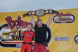 Hope City Church's Samuel Donahue celebrates after winning Tuesday's Faster Pastor school bus race during the Bojangles' Summer Shootout at Charlotte Motor Speedway