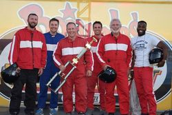 From left: Spectrum News' Matthew East, WCCB's Derek James and race winner Al Conklin from WBTV join WCNC's Nick Carboni, Cabarrus County Channel 22's David Baxter and WJZY's Josh Sims after the Media Mayhem bus race during Tuesday's Bojangles' Summer Shootout at Charlotte Motor Speedway